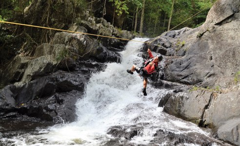 a man riding skis down the side of the water