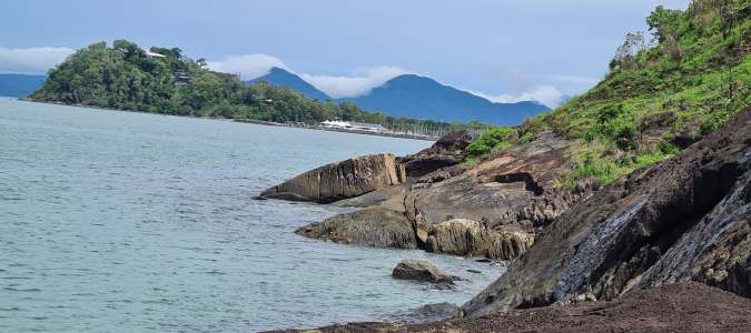 a rocky island in the middle of a body of water